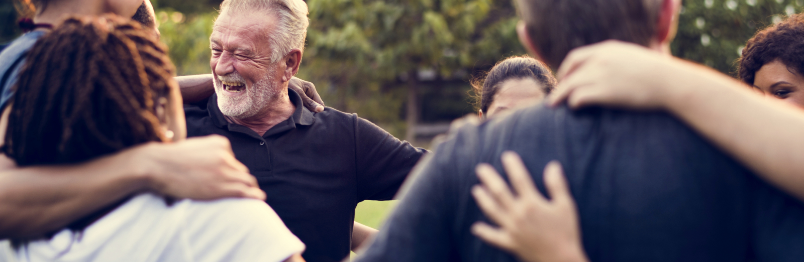 Group of people in a community embracing