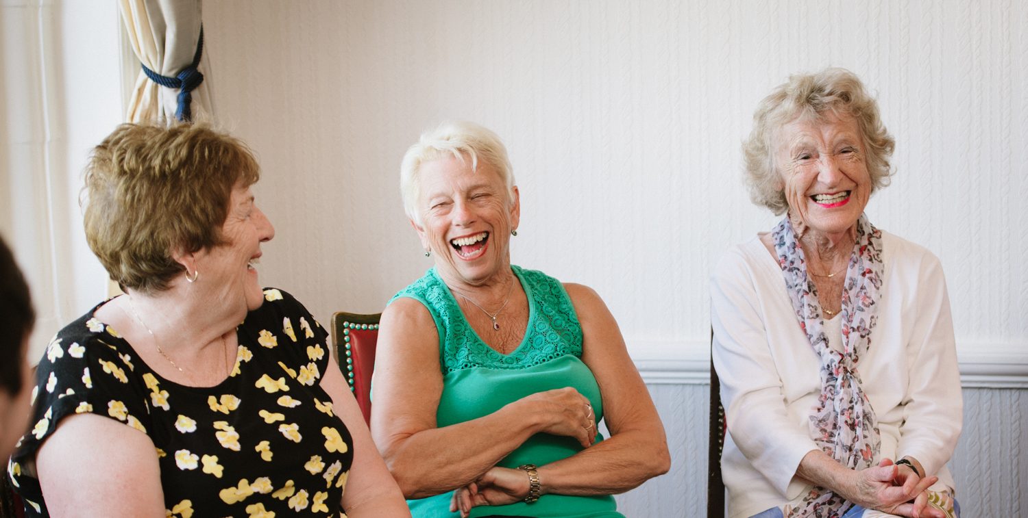 Three women laughing together