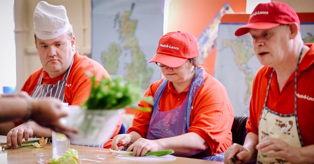 Three people at Motiv8 Lancs cooking