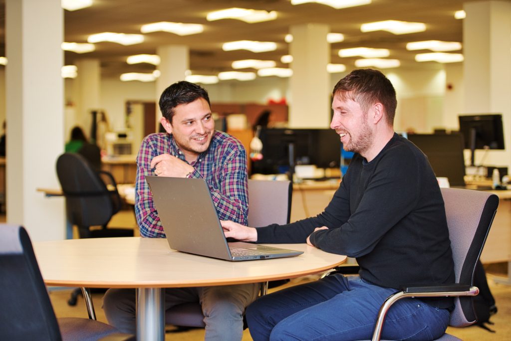 Two staff from CFLM talking in the office